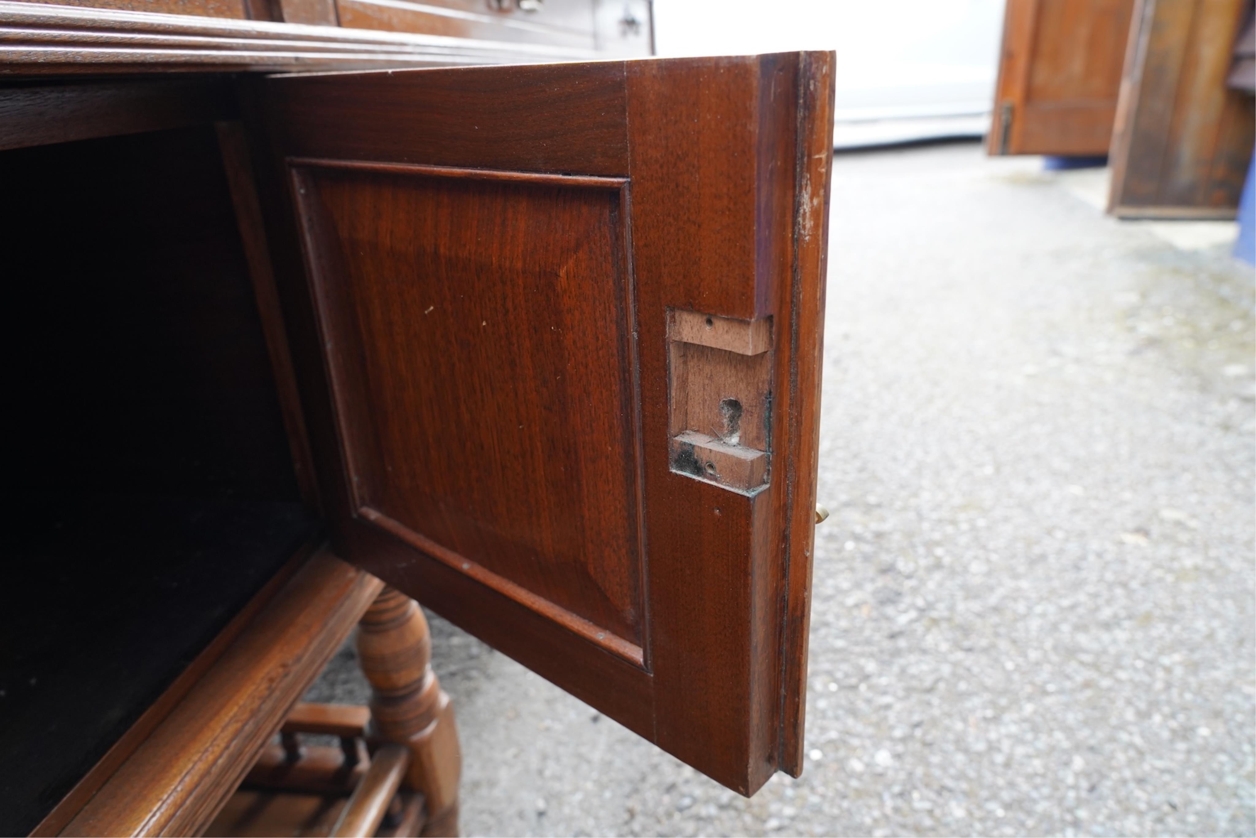 A late Victorian aesthetic movement walnut pedestal partner's desk with galleried undertier by repute from the British Library, width 212cm, depth 121cm, height 77cm. Condition - fair